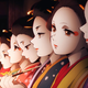A screenshot from the anime shows women in make up waiting for customers and smoking pipes.